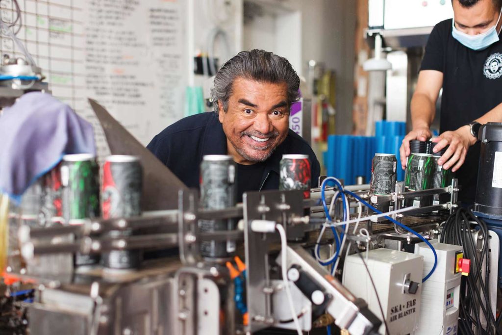 George Lopez watching beer can production